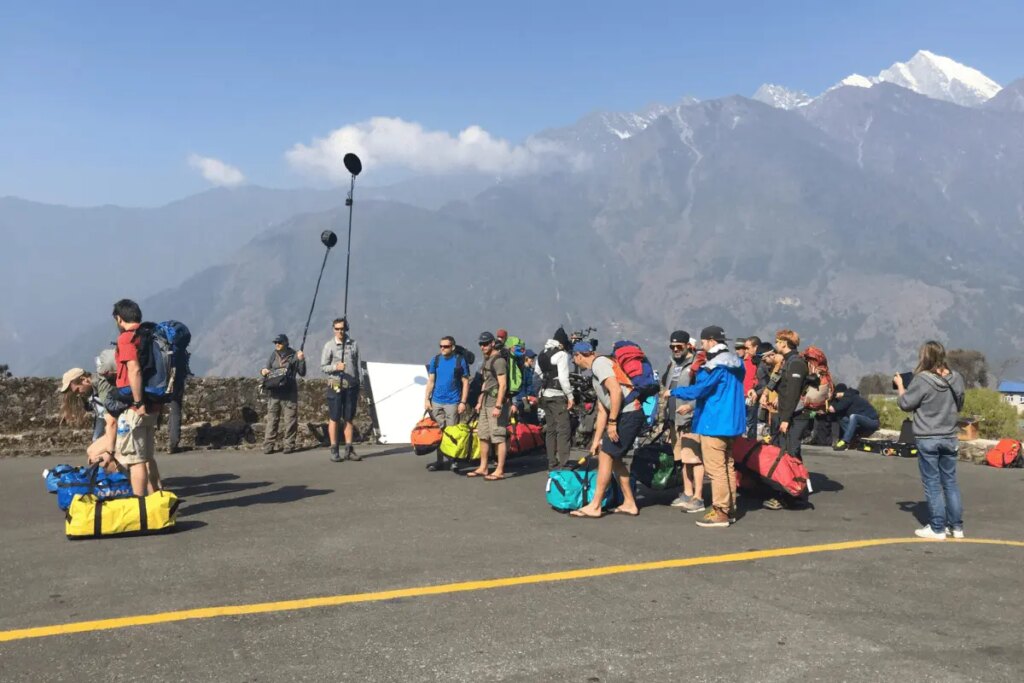 International film crew conducting production planning in Nepal during an on-location shoot
