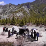 Film crew set up with equipment and vehicles in a rocky Himalayan valley during a production covered by film permits in Nepal