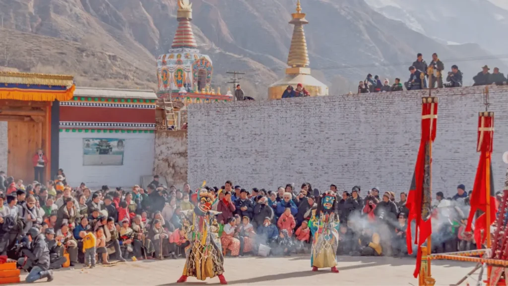 Filming Nepal’s Festivals: The Insider Guide to Accessing the World’s Most Cinematically Extraordinary Cultural Events filming tiji festival with masked dancer surrounder by the viewers