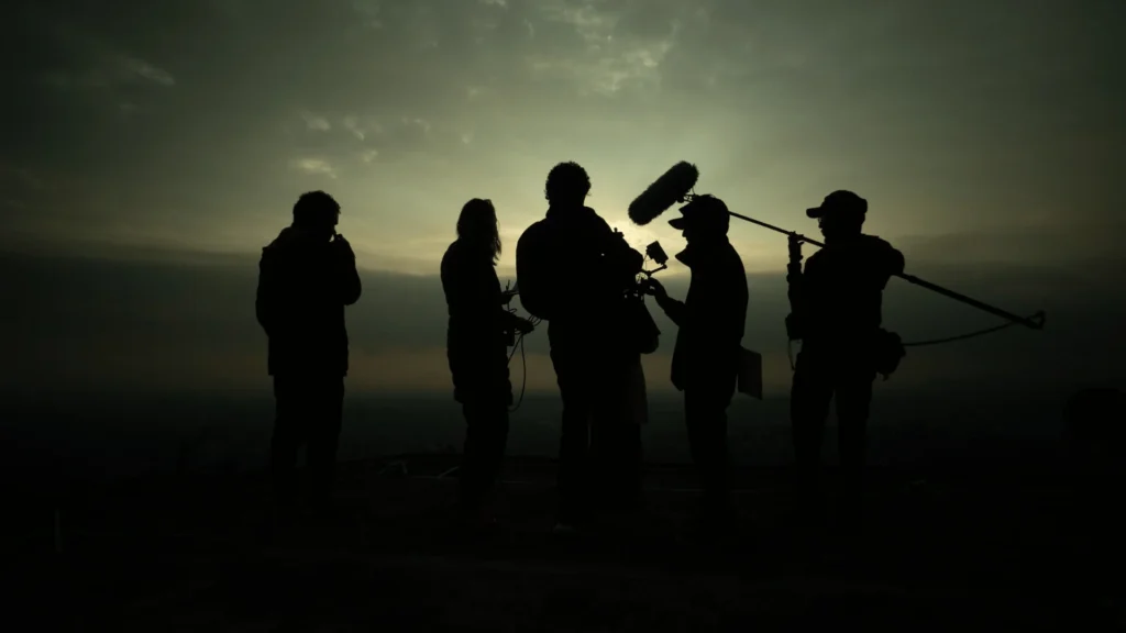 Working with Local Nepali Crew and Fixers: What International Productions Should Expect Local Nepali crew on location at sunset during an international film production in Kathmandu